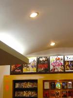 movie posters displayed above DVD racks